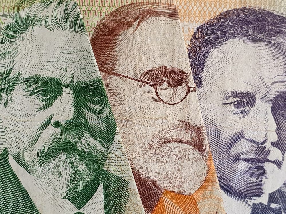 A macro close-up of three portraits from different Uruguayan banknotes