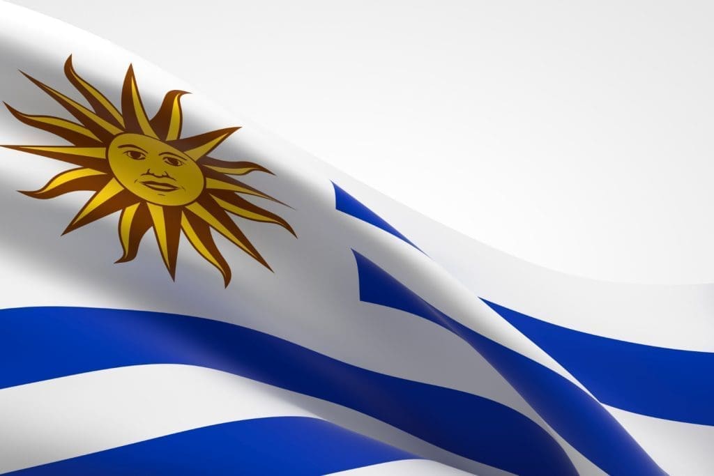 Close-up of a 3D rendered, waving Uruguayan national flag showing the Sun of May.